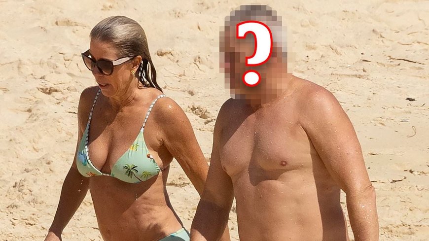 Guess who? Nineties heartthrob strips off and enjoys some fun in the sun with new partner who bears a striking resemblance to his long-term ex