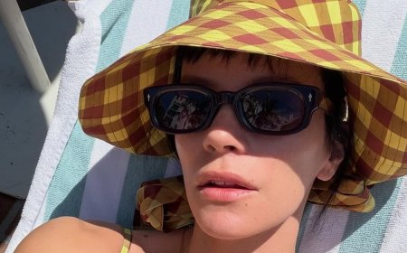 Lily Allen soaks up the sun in a green swimsuit while lounging poolside during downtime from her US tour