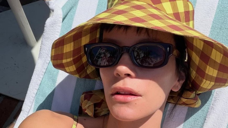 Lily Allen soaks up the sun in a green swimsuit while lounging poolside during downtime from her US tour