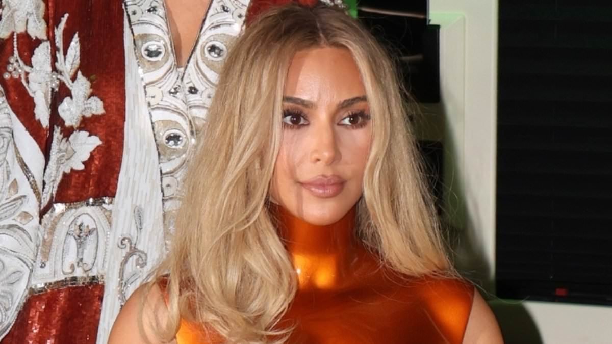 Kim Kardashian reveals her phone lock screen photo is just ONE of her four children as she arrives back at her hotel in New York after the Met Gala