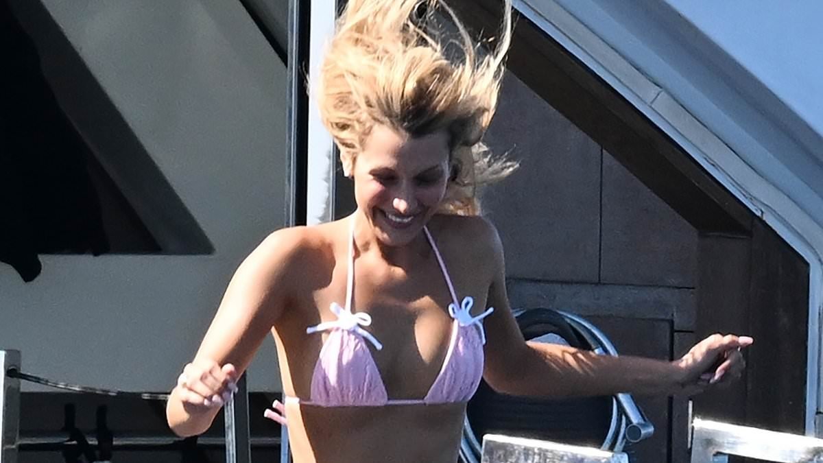 Bella Hadid shows off her supermodel figure in a pink bikini as she cools off on a luxury yacht while taking a break from the Cannes Film Festival