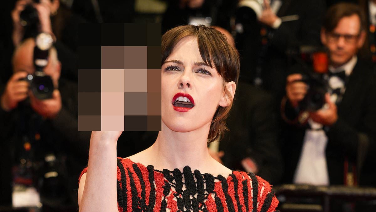Kristen Stewart flips off crowd as she she walks the red carpet alongside Emma Mackey for the Fully Phil Cannes film premiere