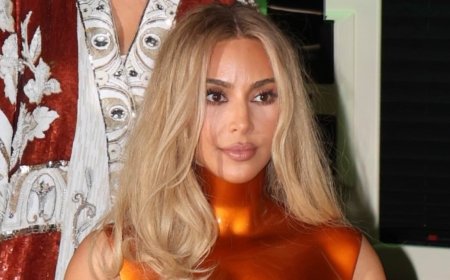Kim Kardashian reveals her phone lock screen photo is just ONE of her four children as she arrives back at her hotel in New York after the Met Gala