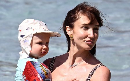 Megan McKenna shows off her gorgeous figure in a plunging swimsuit as she hits the beach with husband Oliver Burke and son Landon, 19-months, amid family getaway in Mallorca