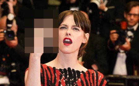 Kristen Stewart flips off crowd as she she walks the red carpet alongside Emma Mackey for the Fully Phil Cannes film premiere