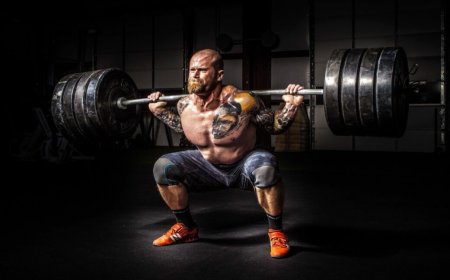 The physics of how Olympic weightlifters exploit barbell's "whip"