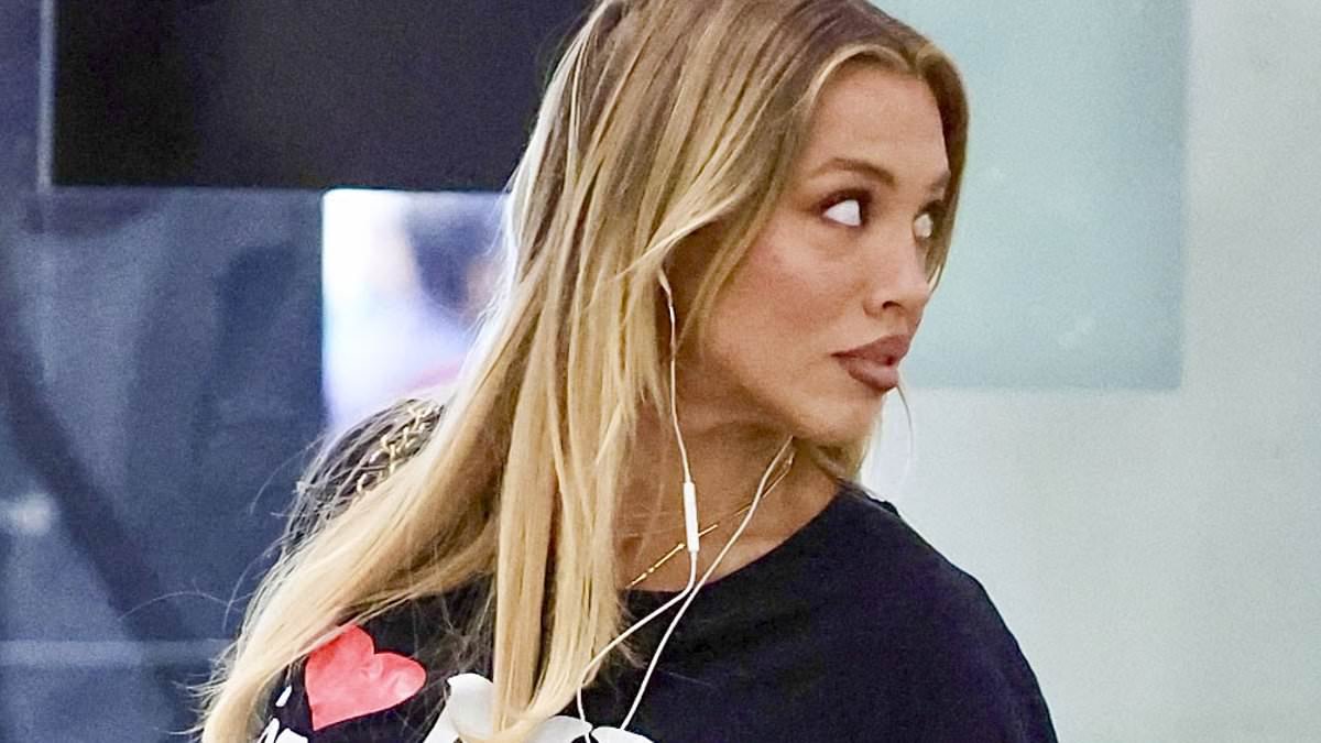 Tammy Hembrow, 32, sends a clear message to her haters as she and her much younger boyfriend, 23, arrive at Sydney Airport