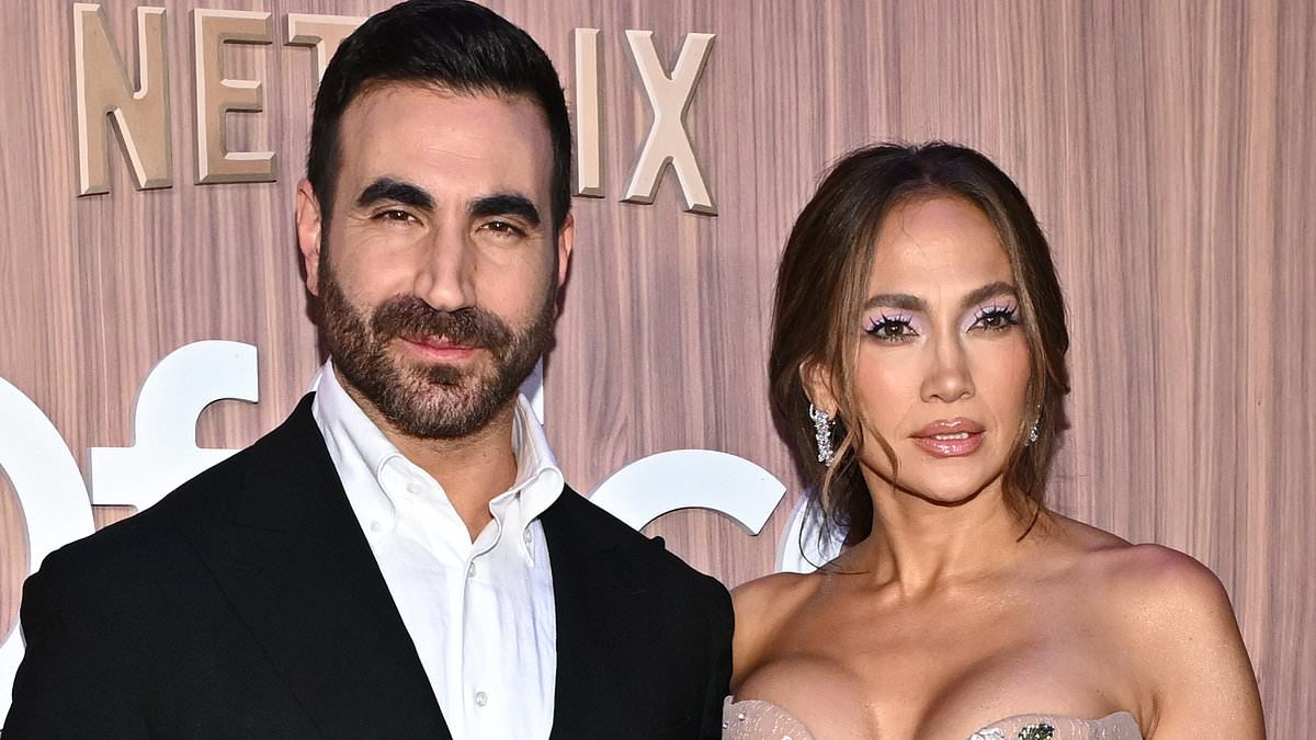 Jennifer Lopez nearly busts out of strapless floral gown as she cozies up to Brett Goldstein at Office Romance premiere in NYC... after addressing dating rumors