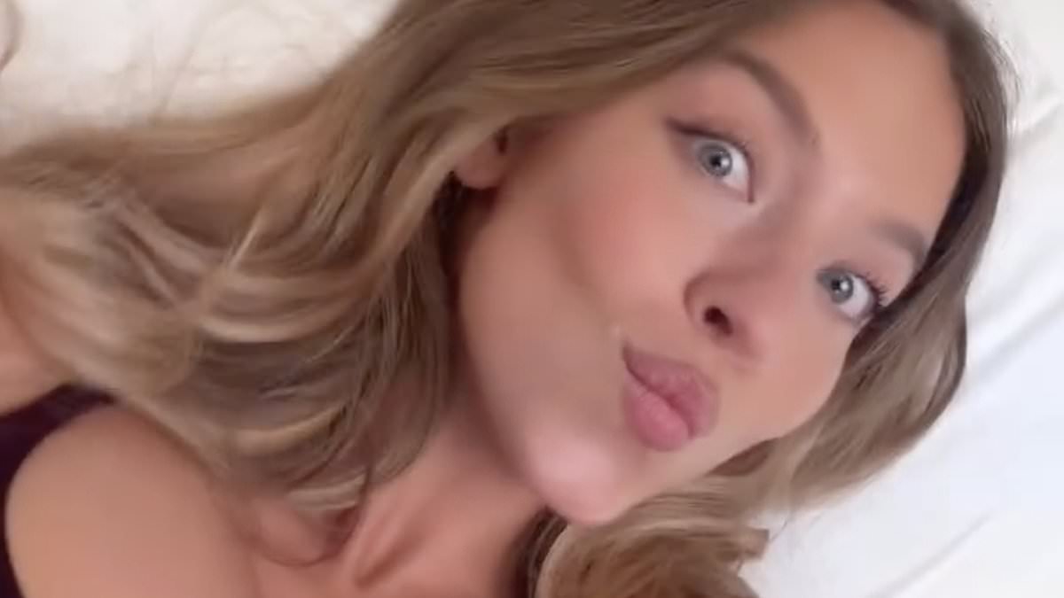 Sydney Sweeney flaunts famous cleavage in skimpy two-piece as she films herself in bed... after Euphoria boss defended her OnlyFans storyline