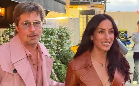 Brad Pitt, 62, steals the spotlight from girlfriend Ines de Ramon, 33, in a bold pink coat as couple continue romantic weekend in Paris with cosy dinner date