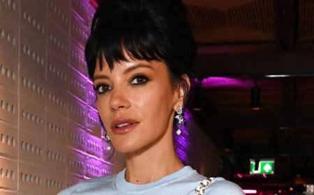 Lily Allen flashes her toned abs in a chic blue crop top and black mini skirt as she leads the star-studded Perfect Magazine X Marc Jacobs Beauty Relaunch Party