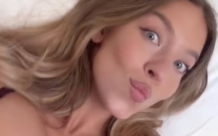 Sydney Sweeney flaunts famous cleavage in skimpy two-piece as she films herself in bed... after Euphoria boss defended her OnlyFans storyline