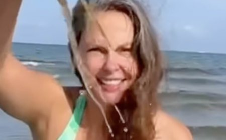 Ashley Judd slips into plunging green and white swimsuit at 58 as she frolics in the Baltic Sea