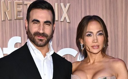 Jennifer Lopez nearly busts out of strapless floral gown as she cozies up to Brett Goldstein at Office Romance premiere in NYC... after addressing dating rumors