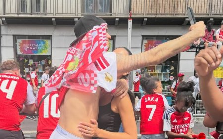 Romeo Beckham snaps a PDA-filled selfie with girlfriend Kim Turnbull as they join thousands of Gunners fans at Arsenal's victory parade despite their Champions League heartbreak
