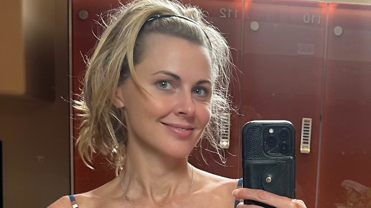 Donna Air shows off her figure as she strips to a striped bikini while 'trying to stay cool' in the heatwave