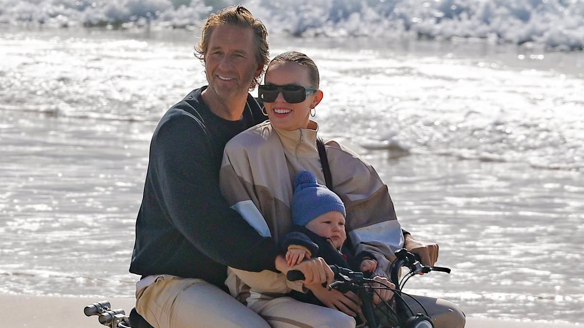 Billionaire Justin Hemmes seen riding an e-bike with his partner Madeline Holtznagel and their one-year-old son all without helmets in Byron Bay