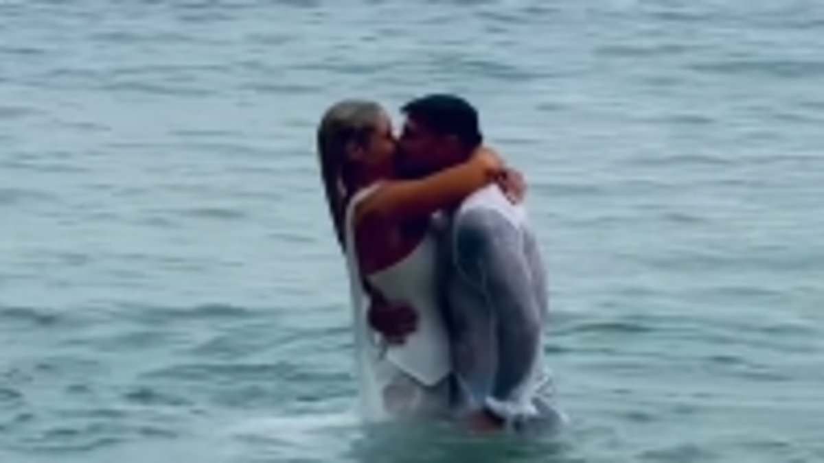 Love Island's Lucie Donlan runs into the ocean in her wedding dress with husband Luke Mabbott as they tie the knot in Cornwall after five-year engagement