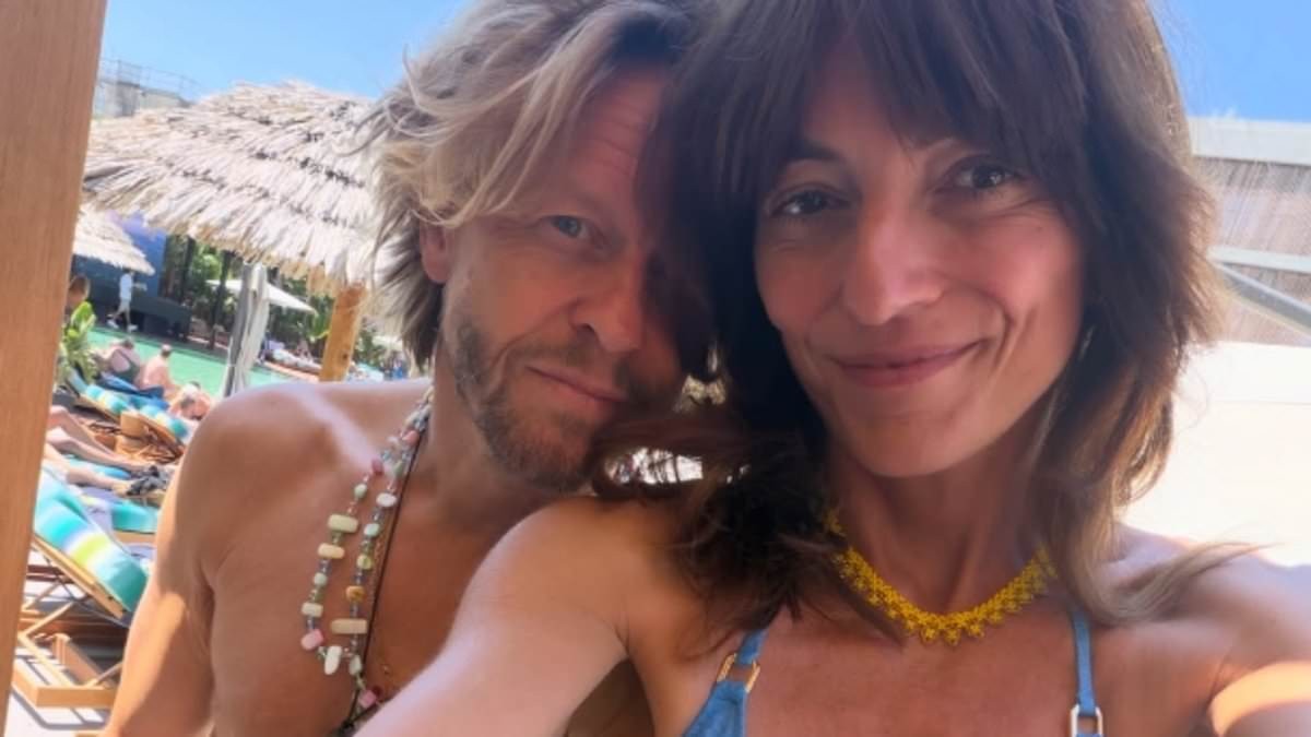 Davina McCall, 58, shows off her six-pack abs in a purple crop top as she amuses fans with bizarre question about her tummy button