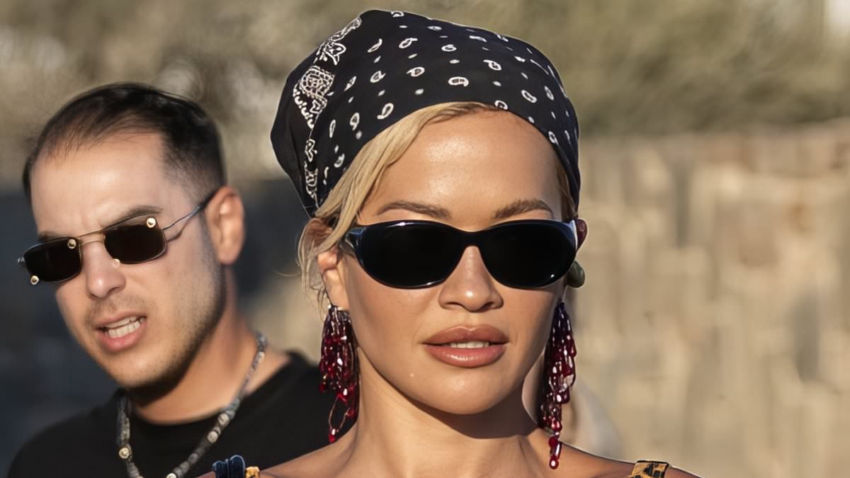 Rita Ora teams her leopard print bikini with teetering heels as she shows off her jaw-dropping abs on a night out with her pals in Mykonos