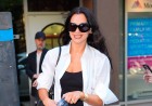 Dua Lipa shows off her honeymoon tan and flashes her new wedding ring as she leaves the studio in New York