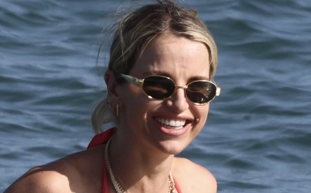 Pregnant Vogue Williams shows off her baby bump in a red bikini as Spencer Matthews lugs the bags to the beach on family holiday to Spain