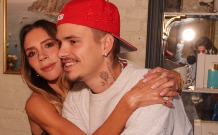 Victoria Beckham hugs supportive son Romeo, 22, and daughter Harper, 15, at her pop-up fragrance launch in NYC - as Brooklyn continues to snub family celebrations