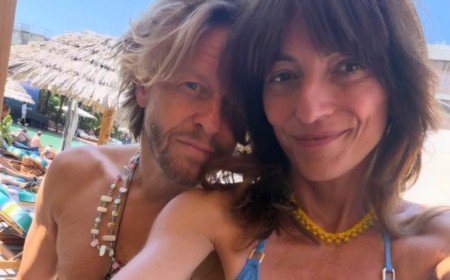 Davina McCall, 58, shows off her six-pack abs in a purple crop top as she amuses fans with bizarre question about her tummy button