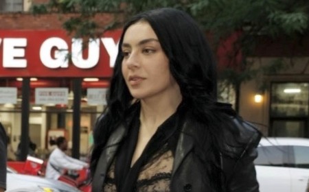 Charli XCX turns heads as she flashes her bra in a sheer lace top while leaving her album listening party in New York City