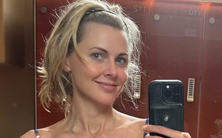 Donna Air shows off her figure as she strips to a striped bikini while 'trying to stay cool' in the heatwave