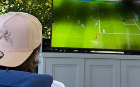 Brooklyn Beckham watches the World Cup final from his sofa at home as his entire family support from the MetLife Stadium - after savage Door Dash ad