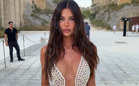Aussie influencer reveals her G-string tan line as she wears a completely see-through dress made out of just pearls to an event in Sicily