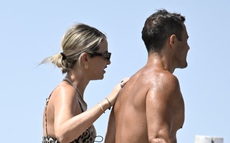 Pregnant Vogue Williams shows off her bump in a leopard print bikini as she enjoys a PDA with Spencer Matthews on the beach in Spain