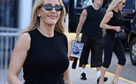 Ellie Goulding, 39, and boyfriend Beau Minniear, 29, display their muscular arms in matching tank tops as they leave the World Cup final