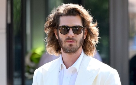 Andrew Garfield's wild long hair leaves him looking 'almost unrecognisable' at Wimbledon as he is overshadowed by Jennifer Lopez's huge hat