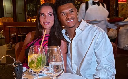 WAG Ellie Watkins looks glamorous in a pink satin top as she enjoys dinner with husband Ollie to celebrate the end of the World Cup