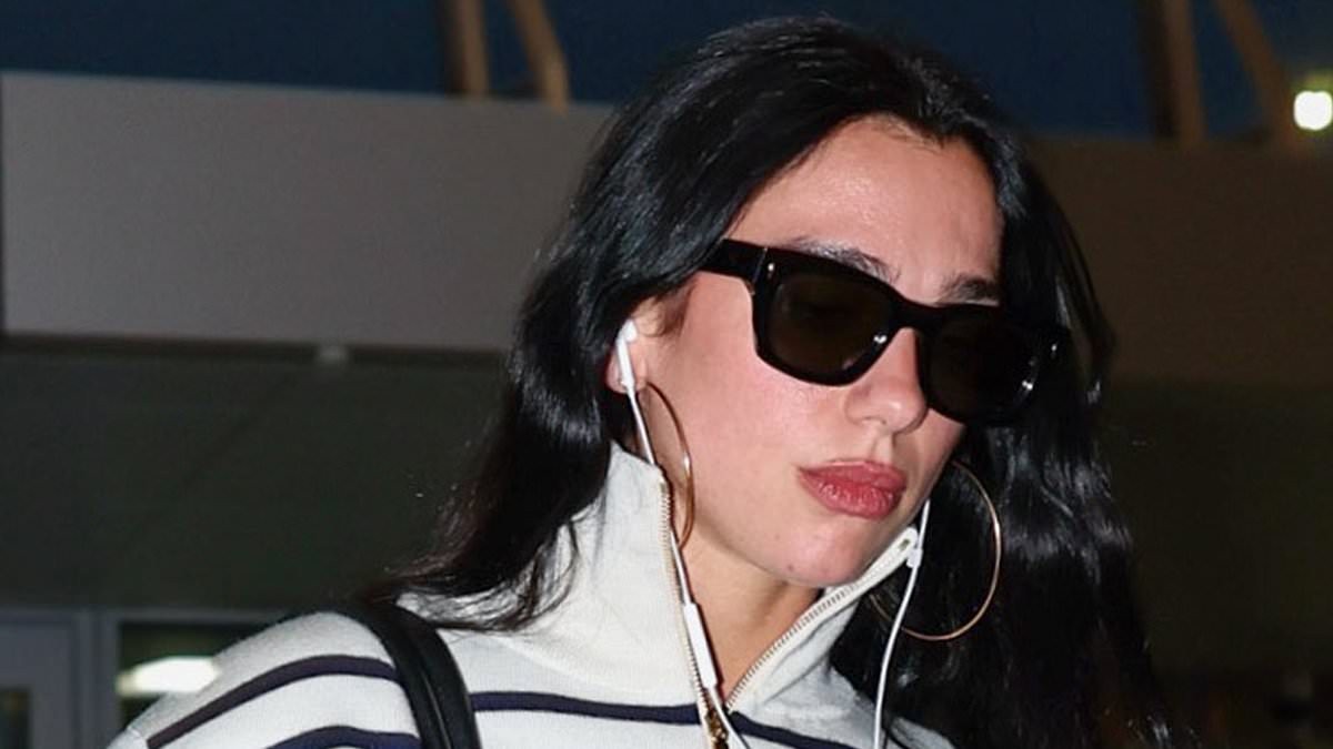 Dua Lipa nails riviera chic in stripes and jeans while making a statement with a VAST Chanel bucket bag as she jets out of JFK Airport