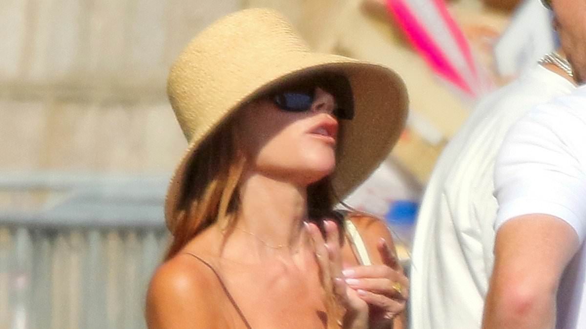 Victoria Beckham, 52, wows in stylish brown satin dress as she takes fashion inspiration from daughter Harper's wardrobe as family head into St Tropez amid £16M luxury yacht holiday
