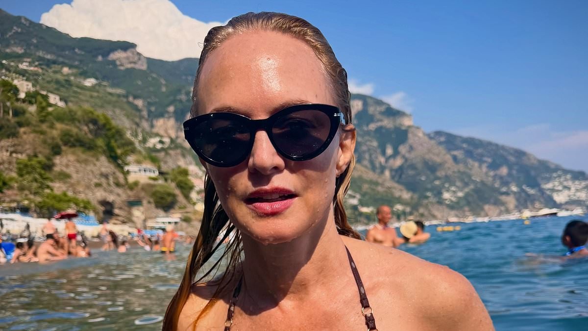 Heather Graham, 56, showcases her incredible figure in a maroon bikini as she frolics in the sea during sun-soaked Italian getaway