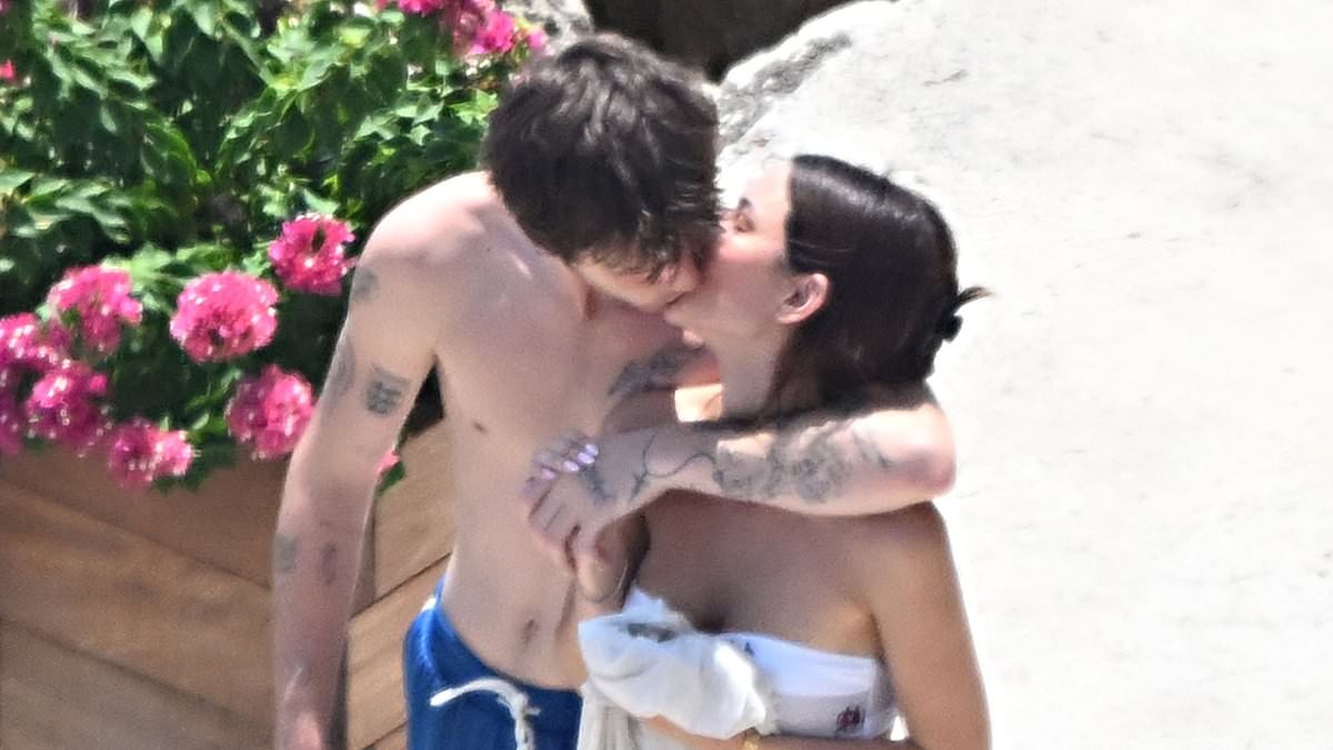 Cruz Beckham, 21, plants a passionate kiss on his bikini-clad girlfriend Jackie Apostel, 30, as they soak up the sun during family trip to the Amalfi Coast