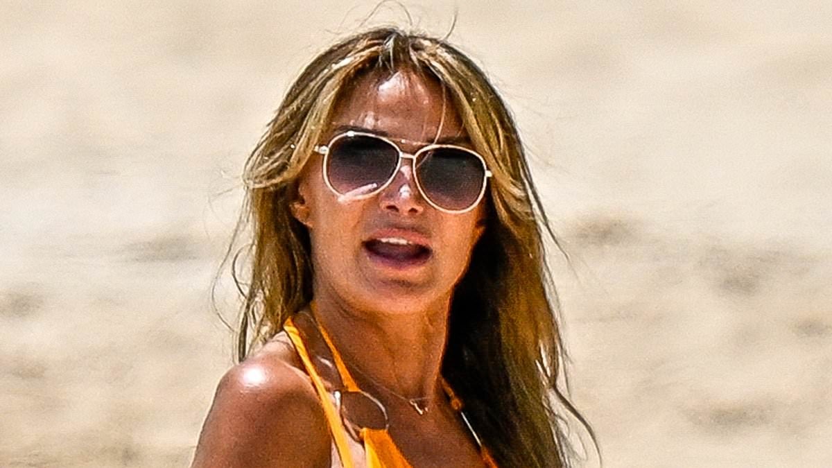 Lizzie Cundy, 58, looks sensational in plunging orange swimsuit as she hits the beach in Barbados after stay on billionaire James Packer's £260million superyacht in Majorca