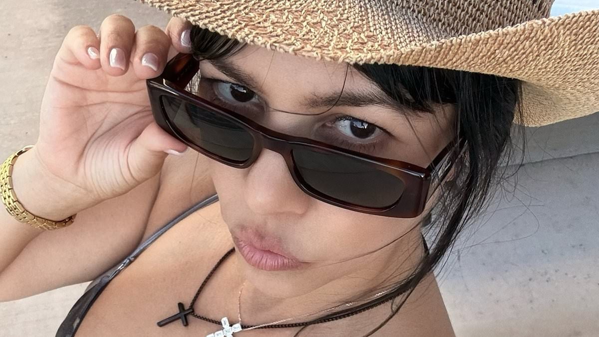 Kourtney Kardashian, 47, models skimpy silver bikini on family vacation with husband Travis Barker and kids