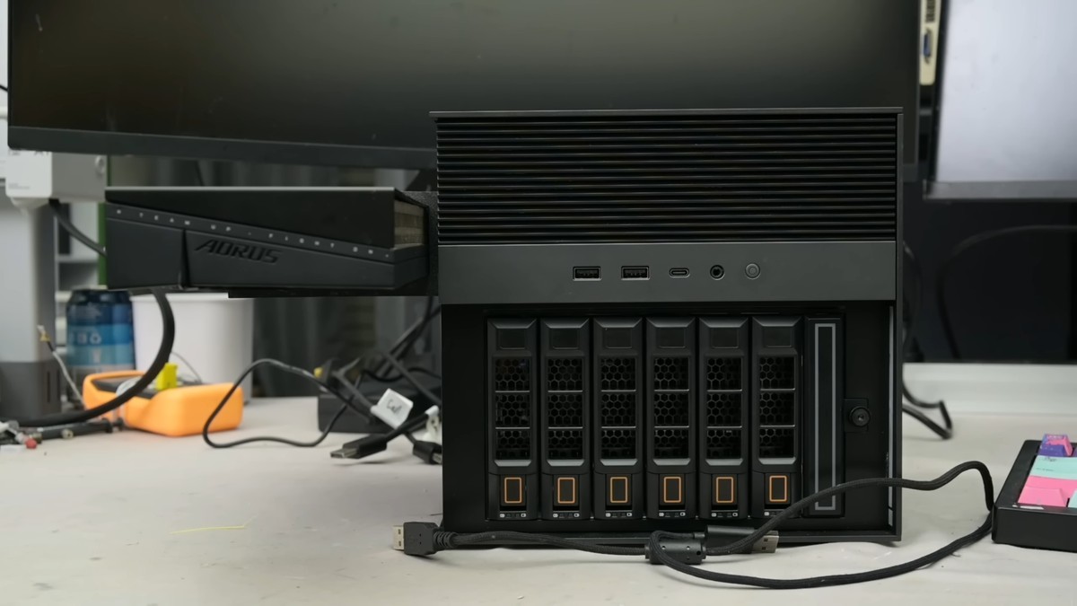 Crazed modder turns NAS into a gaming PC with RTX 5060 hanging from the side, boosts frame rate by 828% — Frankenstein rig hides dedicated PSU in drive bay, breaks Time Spy world record for the onboard CPU