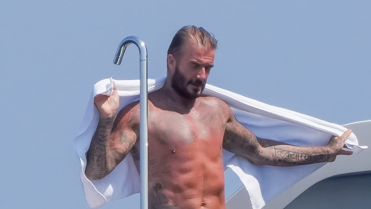 David Beckham shows off his sexy side as he towels off after a shower on board luxury superyacht in the South of France