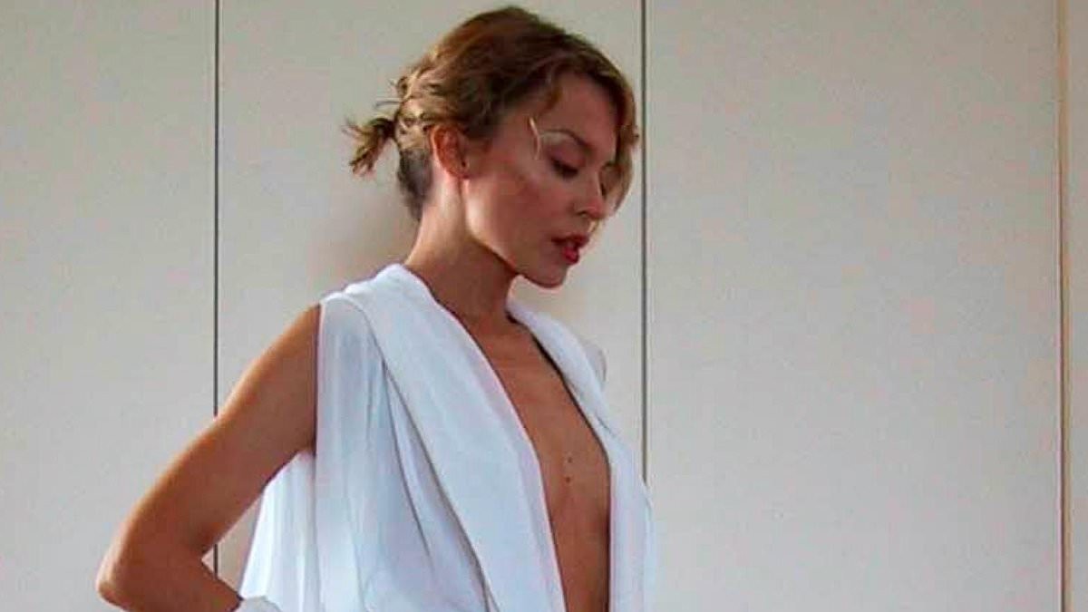 Kylie Minogue, 58, shares throwback snaps in her iconic Can't Get You Out Of My Head jumpsuit 25 years on as it reaches a billion streams on Spotify