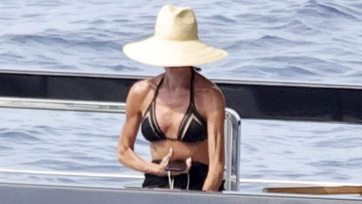 Victoria Beckham shows off her toned figure in a black bikini as she relaxes with shirtless husband David on their yacht near Capri amid summer break