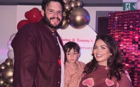 Scarlett Moffatt shows off her baby bump in a heart print dress as she kisses fiancé Scott Dobinson ahead of welcoming their second child
