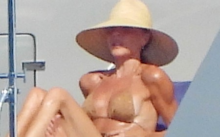 Victoria Beckham leaves little to the imagination in a nude bikini as she relaxes on her yacht in Italy with husband David