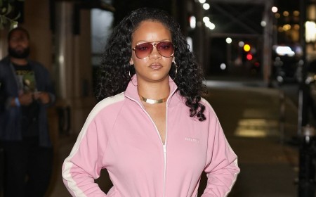 Rihanna looks casually cool in a £2,250 pink Miu Miu jacket as she leaves her hotel in New York with A$AP Rocky and their daughter Rocki