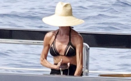 Victoria Beckham shows off her toned figure in a black bikini as she relaxes with shirtless husband David on their yacht near Capri amid summer break